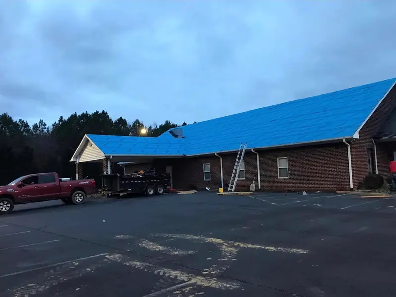 Lopez Brothers Roofing crew and equipment on a commercial re-roof job site
